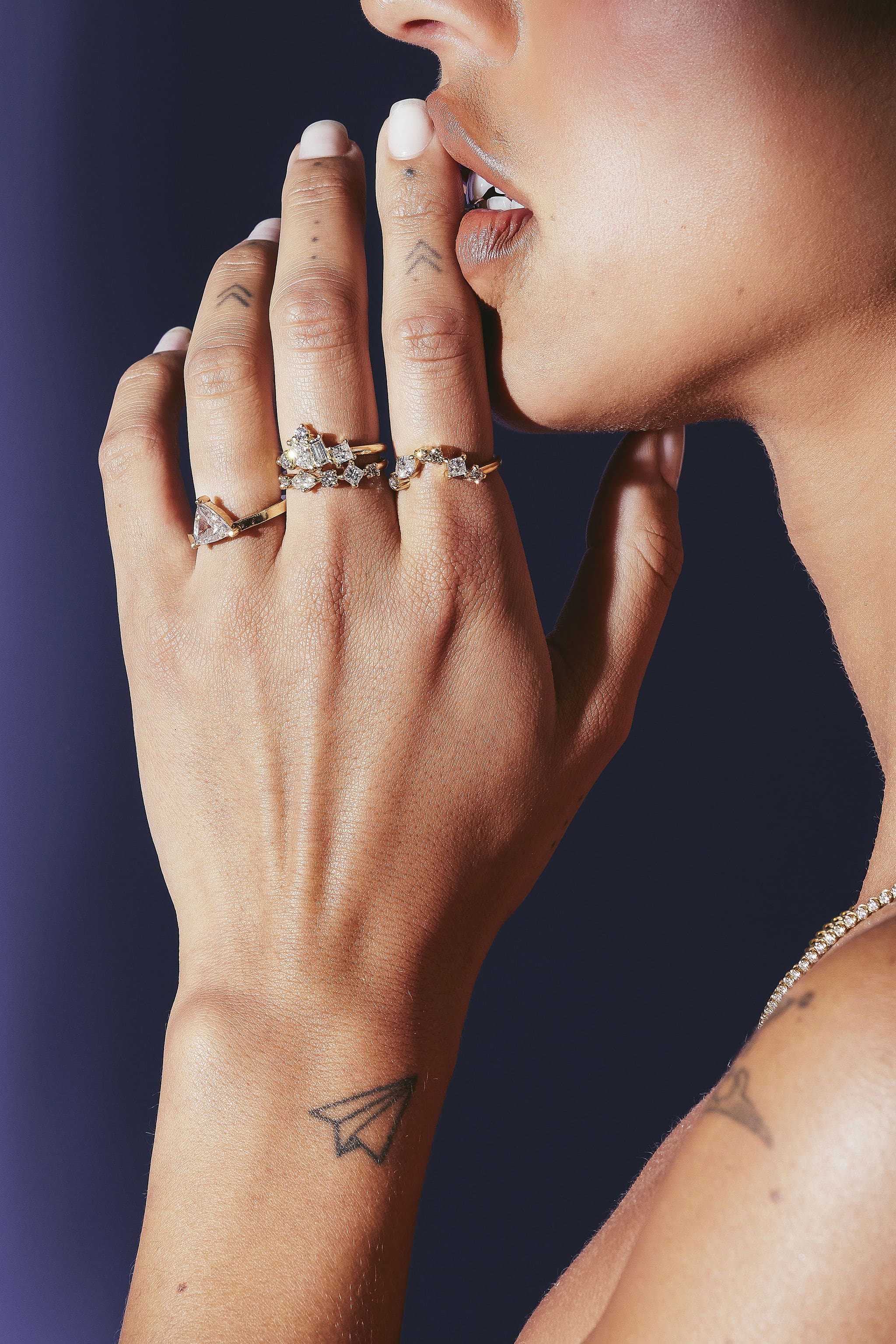 A woman showcasing Black Finch Diamond Rings on her hand