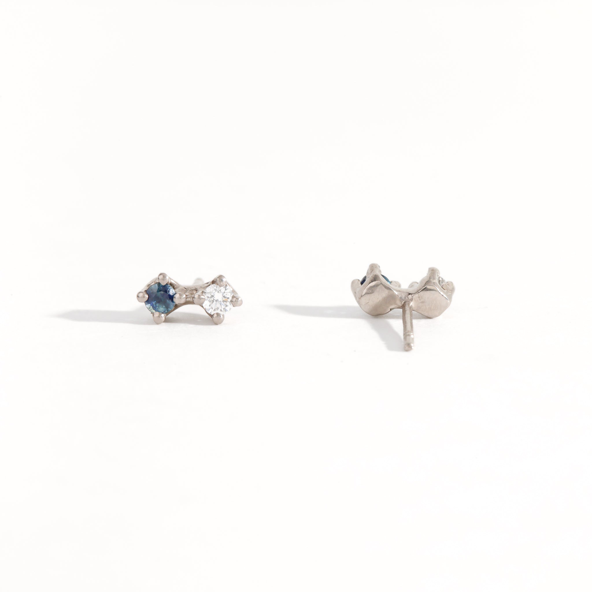 Paid of white gold studs featuring white diamond and Australian blue sapphires. Bespoke, handmade jewellery.