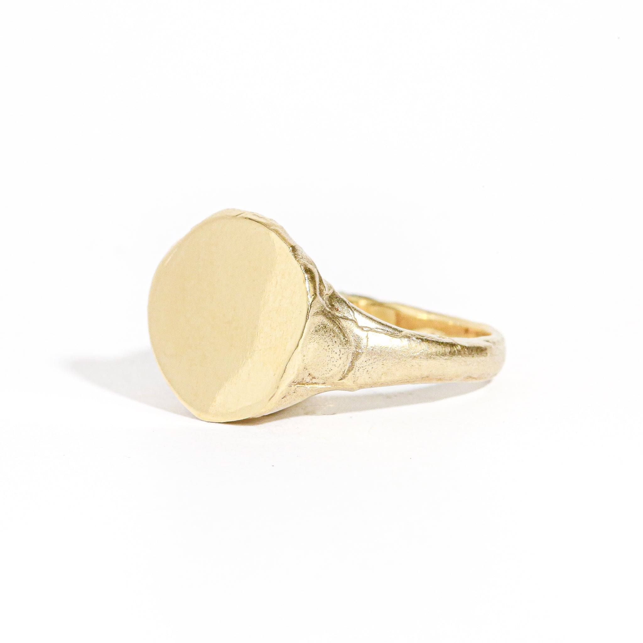 9 carat yellow gold round signet ring with a polished surface and soft matte band.